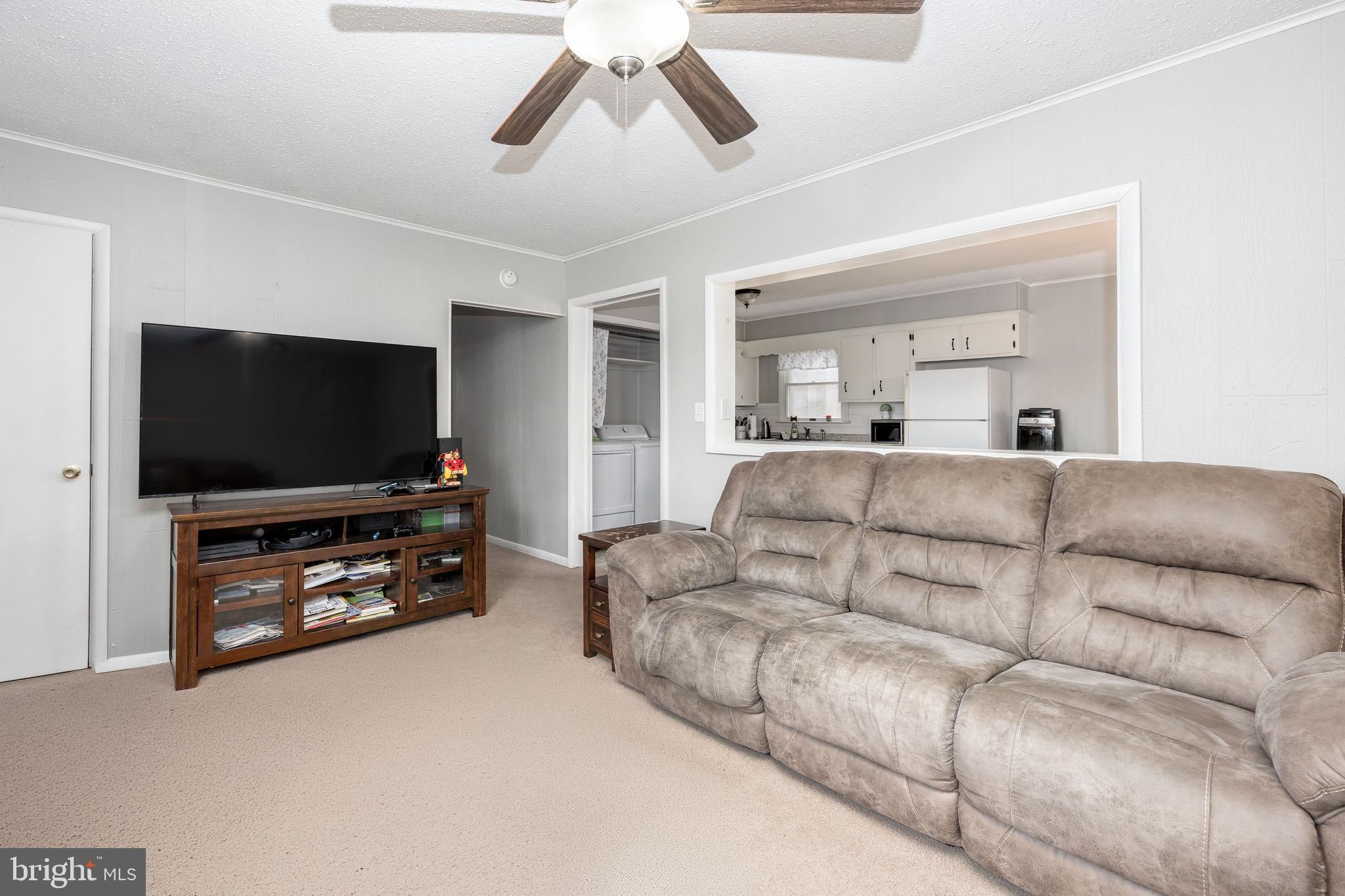 6870 Zion Church Road Salisbury, MD 21804 - Photo 10 of 39 a living room with furniture and a flat screen tv