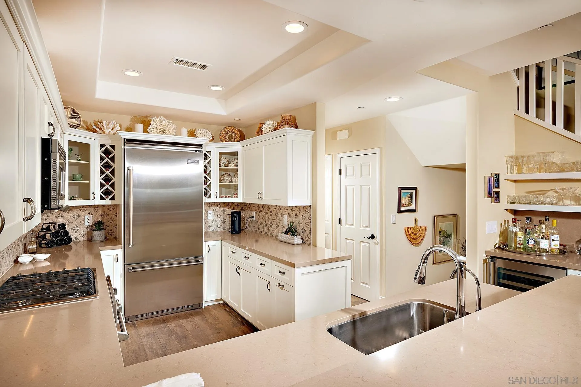 744 Cornish Drive Encinitas, CA 92024 - Photo 13 of 39 a kitchen with stainless steel appliances kitchen island granite countertop a refrigerator and a sink
