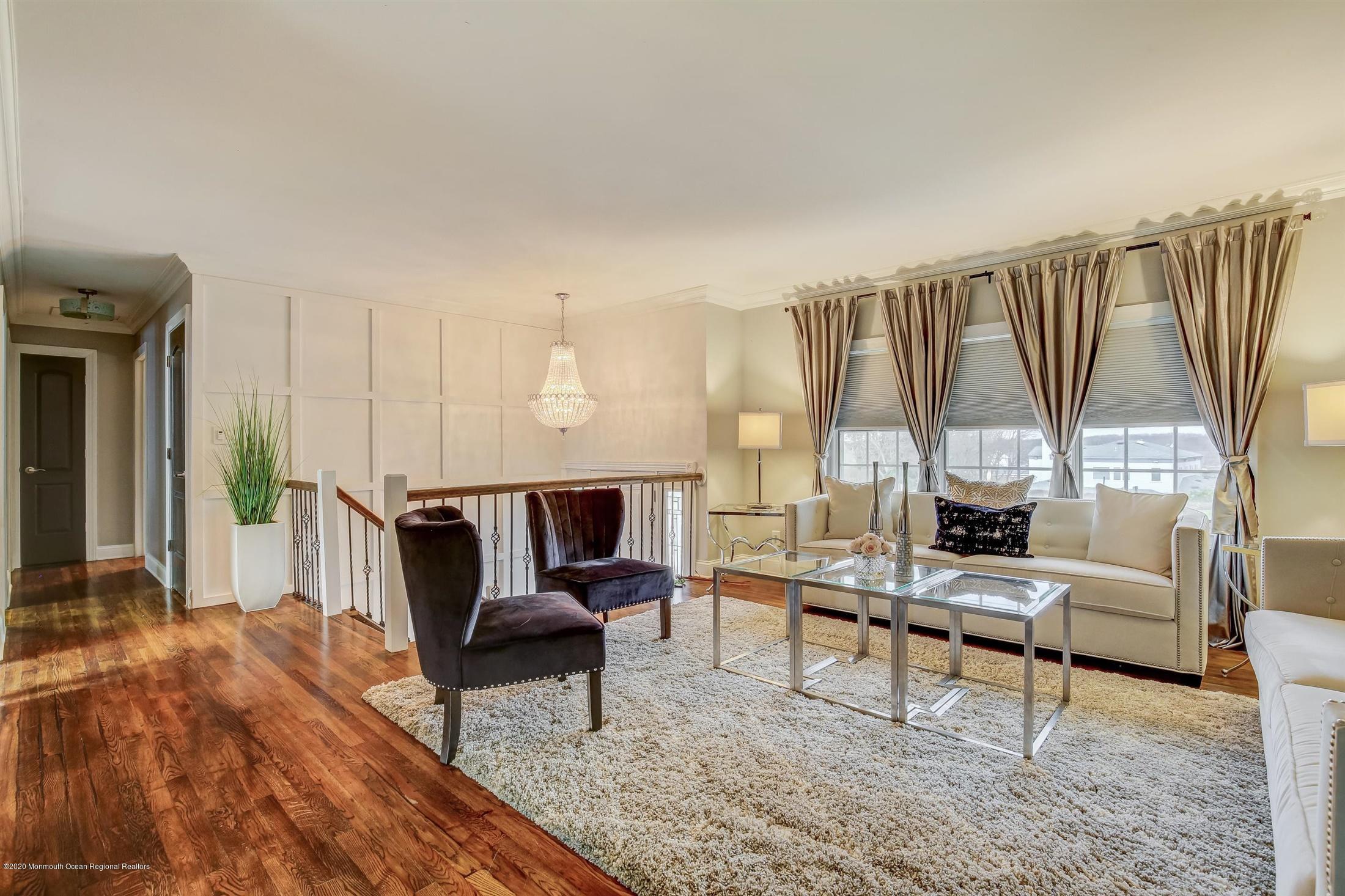 4 Wickatunk Road Manalapan, NJ 07726 - Photo 1 of 23 a living room with furniture and a large window
