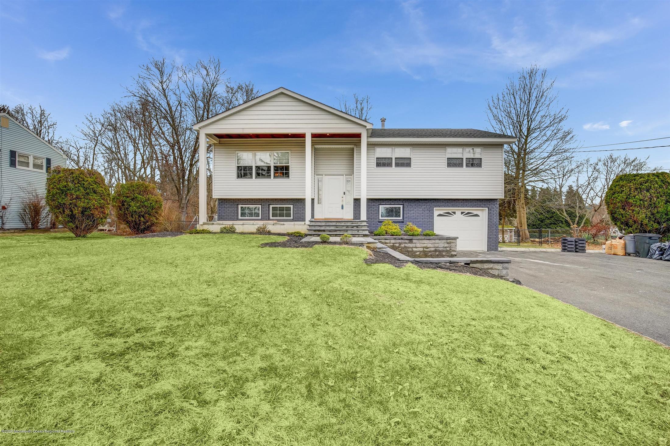 4 Wickatunk Road Manalapan, NJ 07726 - Photo 2 of 23 a front view of a house with a yard and trees