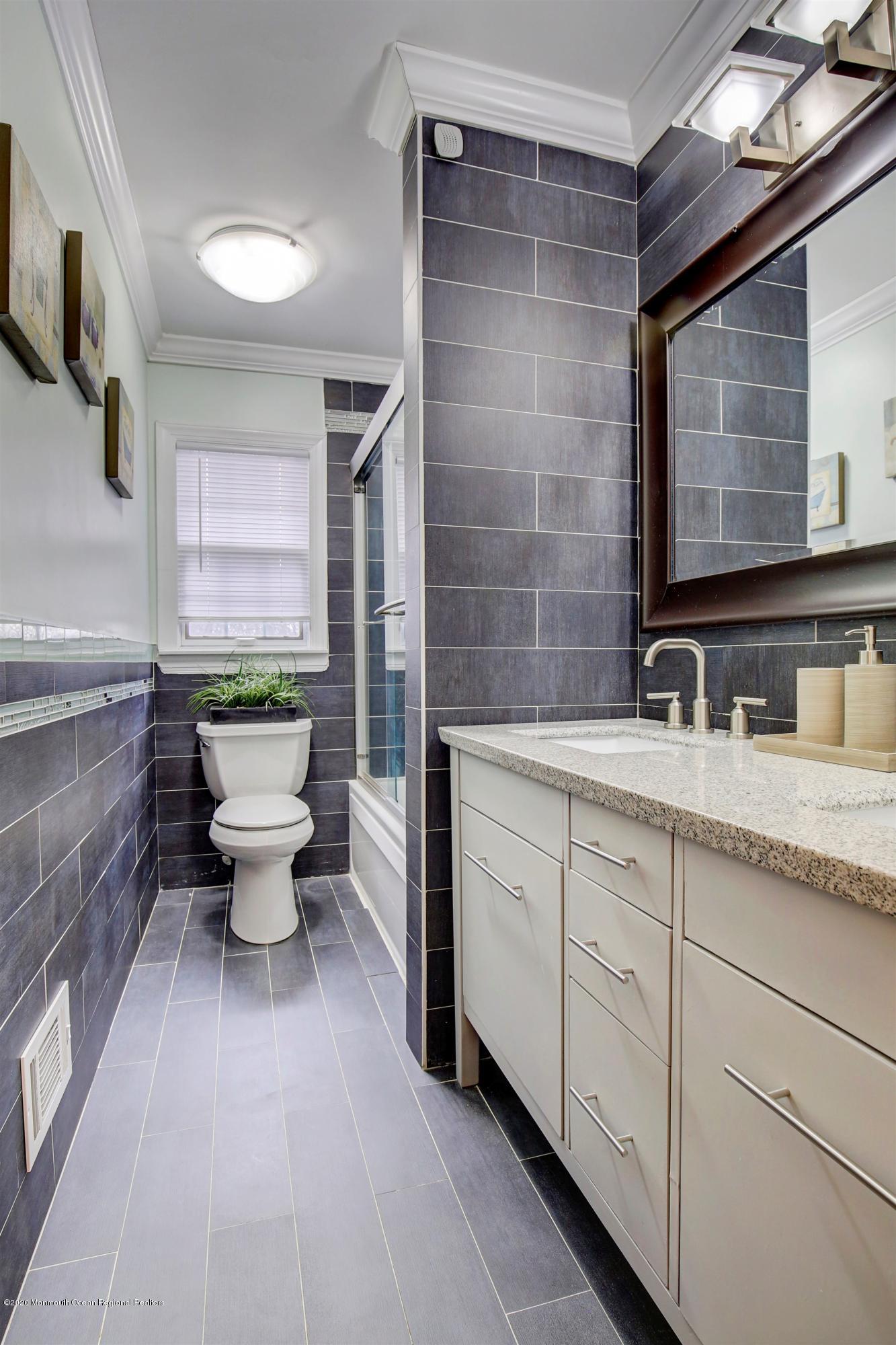 4 Wickatunk Road Manalapan, NJ 07726 - Photo 16 of 23 a spacious bathroom with a double vanity sink a mirror and a bathtub