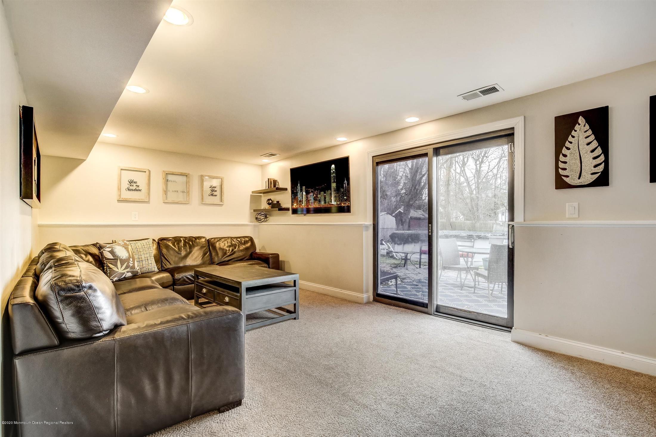 4 Wickatunk Road Manalapan, NJ 07726 - Photo 17 of 23 a living room with furniture a flat screen tv