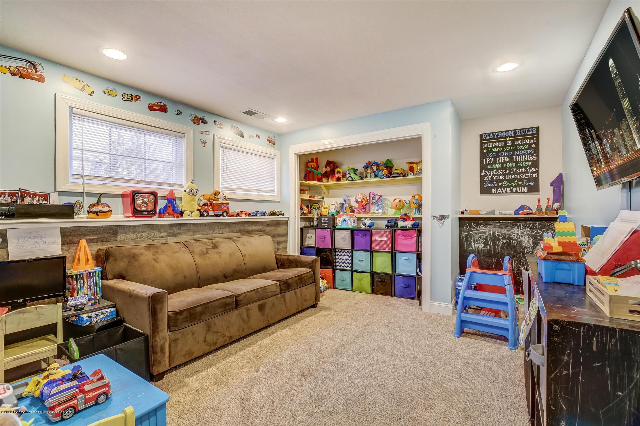 4 Wickatunk Road Manalapan, NJ 07726 - Photo 19 of 23 a living room with furniture and a flat screen tv