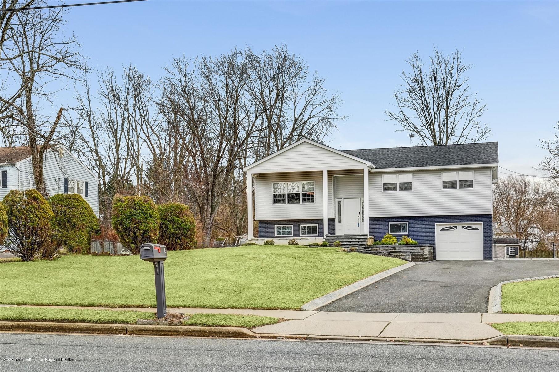 4 Wickatunk Road Manalapan, NJ 07726 - Photo 3 of 23 a front view of a house with a yard