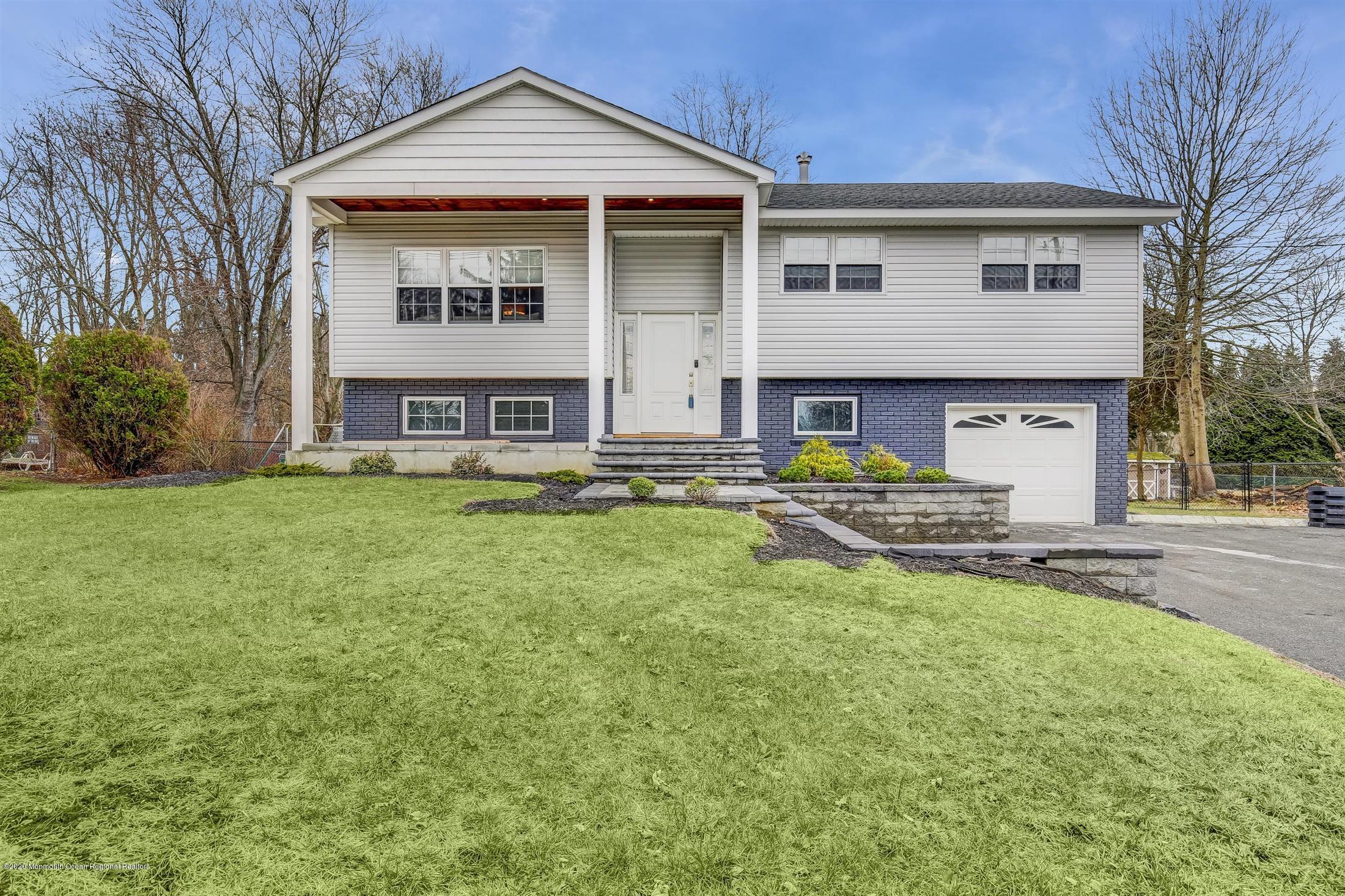 4 Wickatunk Road Manalapan, NJ 07726 - Photo 4 of 23 front view of a house with a yard