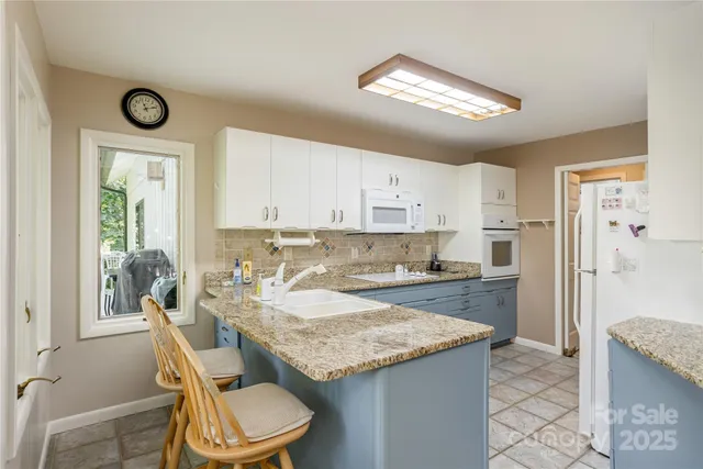a kitchen with a refrigerator a sink and a stove