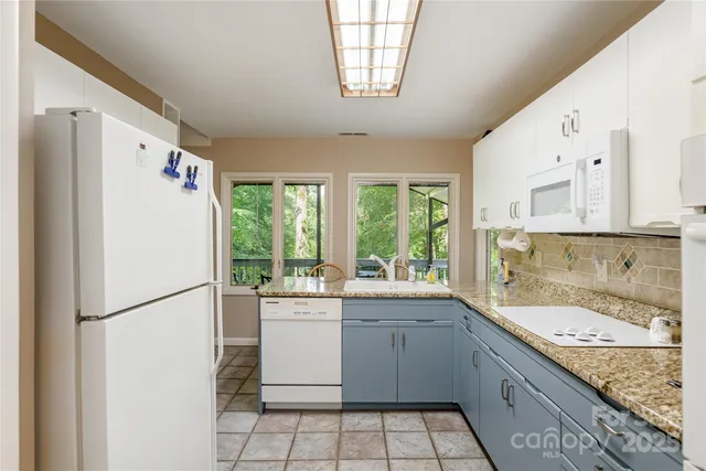 a bedroom with a bed a table and chair