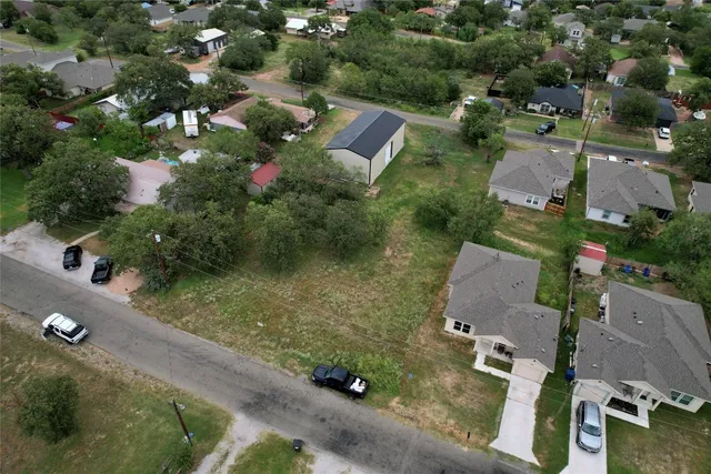 an aerial view of residential house with outdoor space and street view