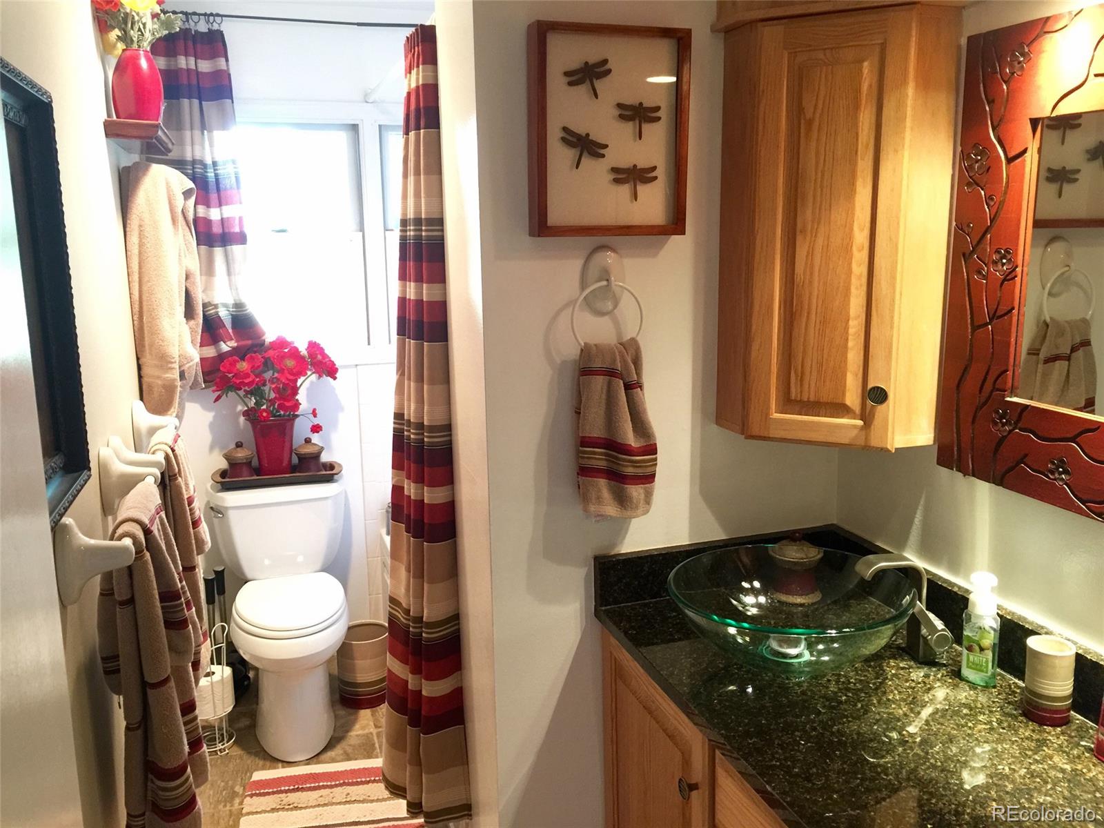 9774 Phillips Road Lafayette, CO 80026 - Photo 17 of 27 a bathroom with a sink toilet and shower