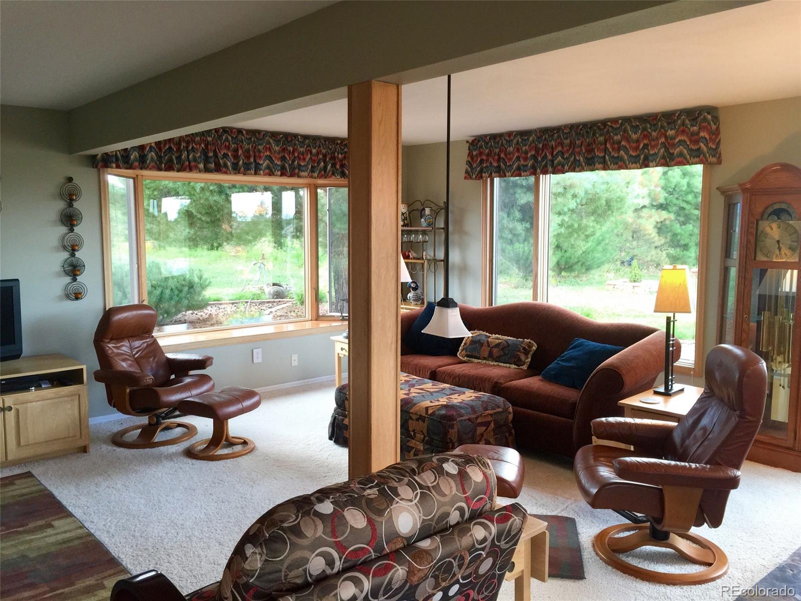 9774 Phillips Road Lafayette, CO 80026 - Photo 19 of 27 a living room with furniture floor to ceiling window and a floor to ceiling window