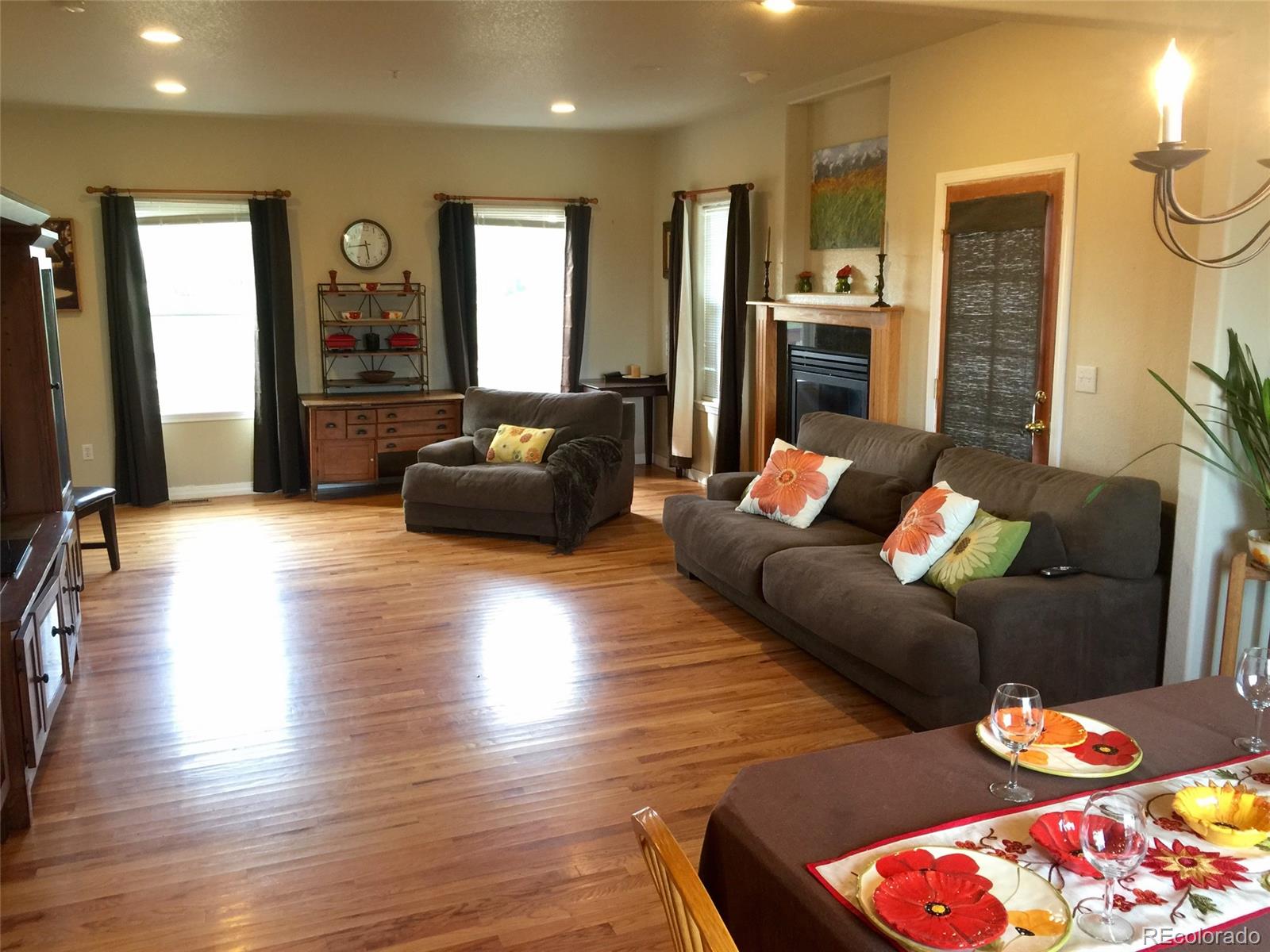 9774 Phillips Road Lafayette, CO 80026 - Photo 22 of 27 a living room with furniture fireplace and wooden floor