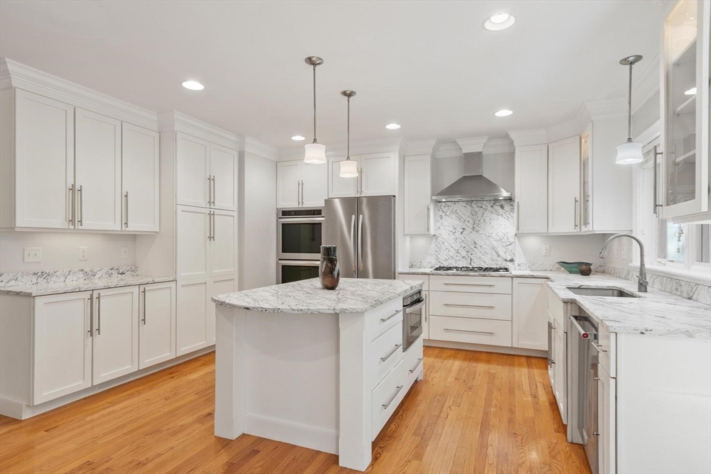 56 Old Marlboro Road Concord, MA 01742 - Photo 5 of 34 a large kitchen with stainless steel appliances granite countertop a stove a sink a refrigerator and white cabinets with wooden floor