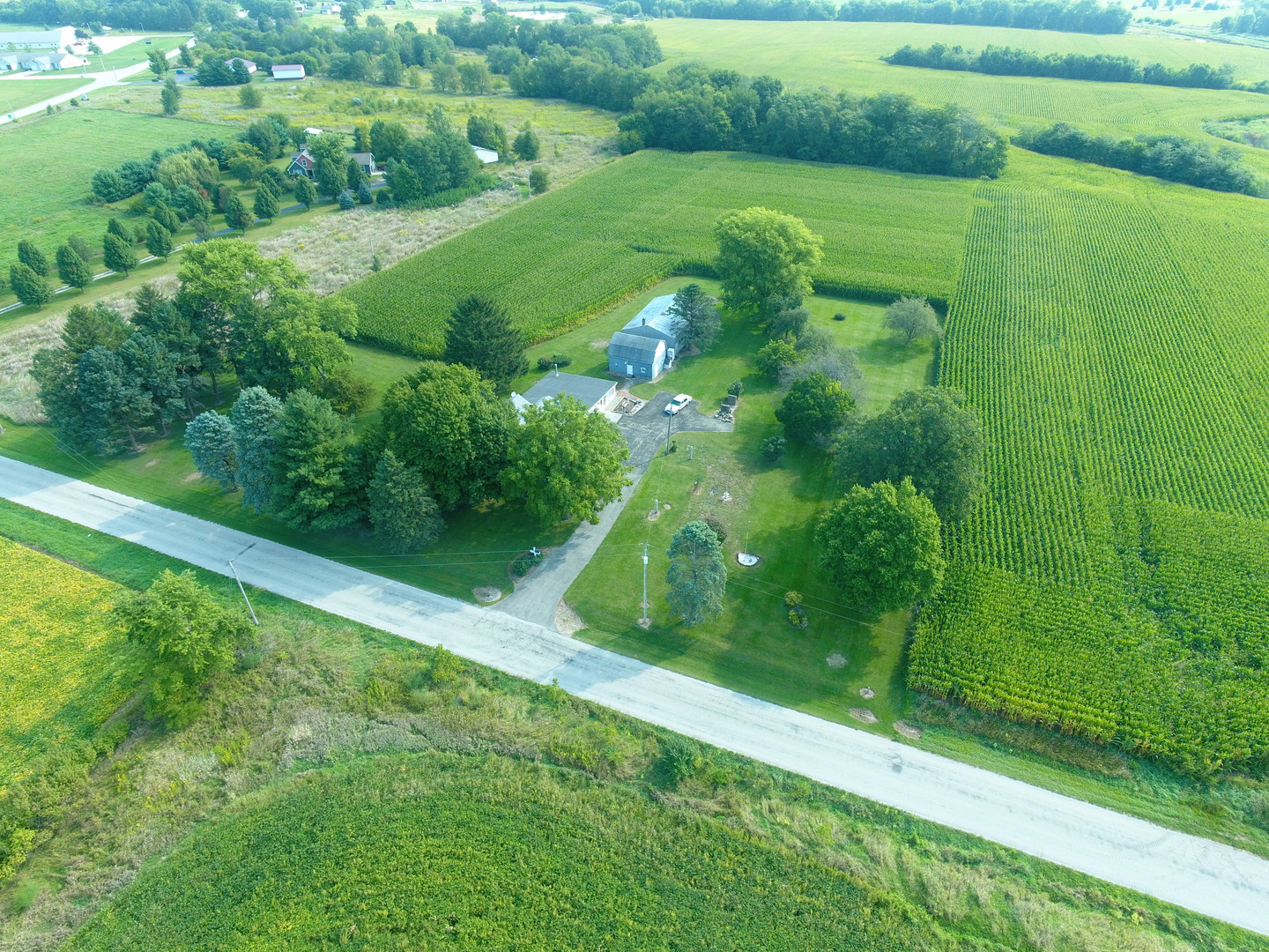 12454 Cracker Road Farmer City, IL 61842 - Photo 2 of 23 a view of a green yard with large trees