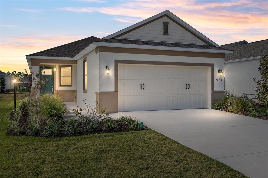 7288 Southwest 89th Avenue Ocala, FL 34481 - Photo 1 of 34 a front view of a house with a yard