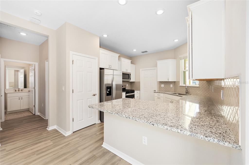 7288 Southwest 89th Avenue Ocala, FL 34481 - Photo 15 of 34 a large kitchen with stainless steel appliances granite countertop a refrigerator and a sink