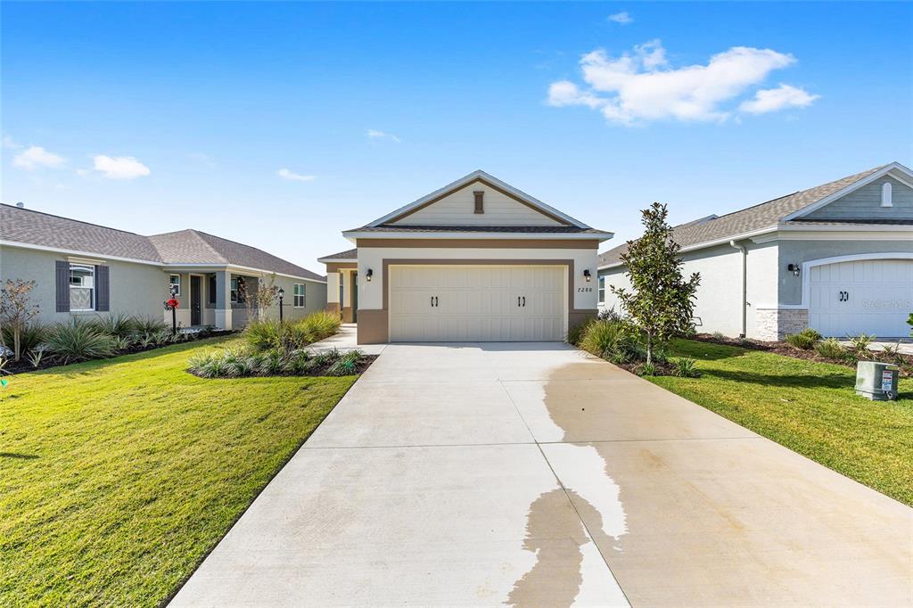 7288 Southwest 89th Avenue Ocala, FL 34481 - Photo 3 of 34 a front view of a house with garden