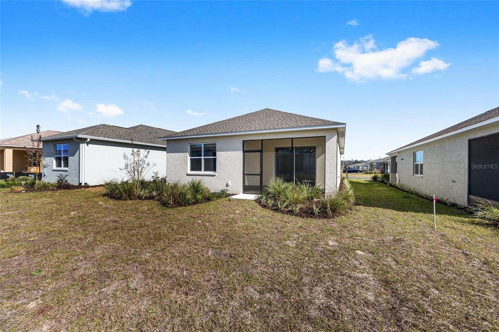 7288 Southwest 89th Avenue Ocala, FL 34481 - Photo 32 of 34 a view of a house with a yard