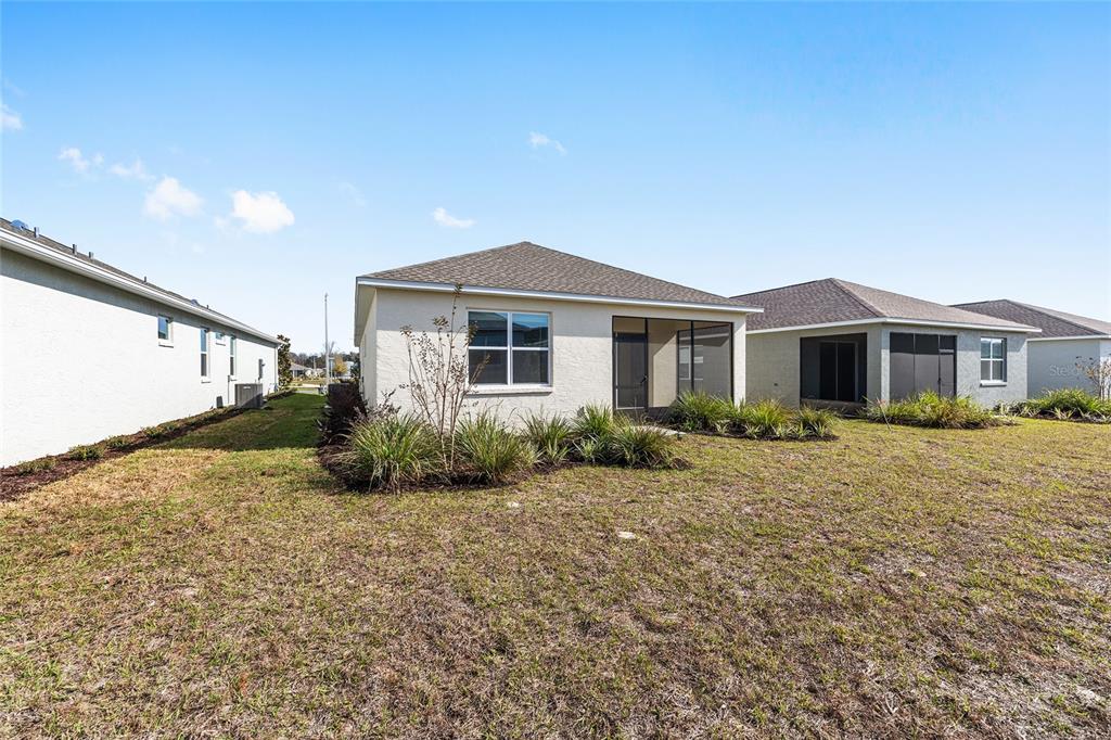 7288 Southwest 89th Avenue Ocala, FL 34481 - Photo 34 of 34 a front view of a house with a garden