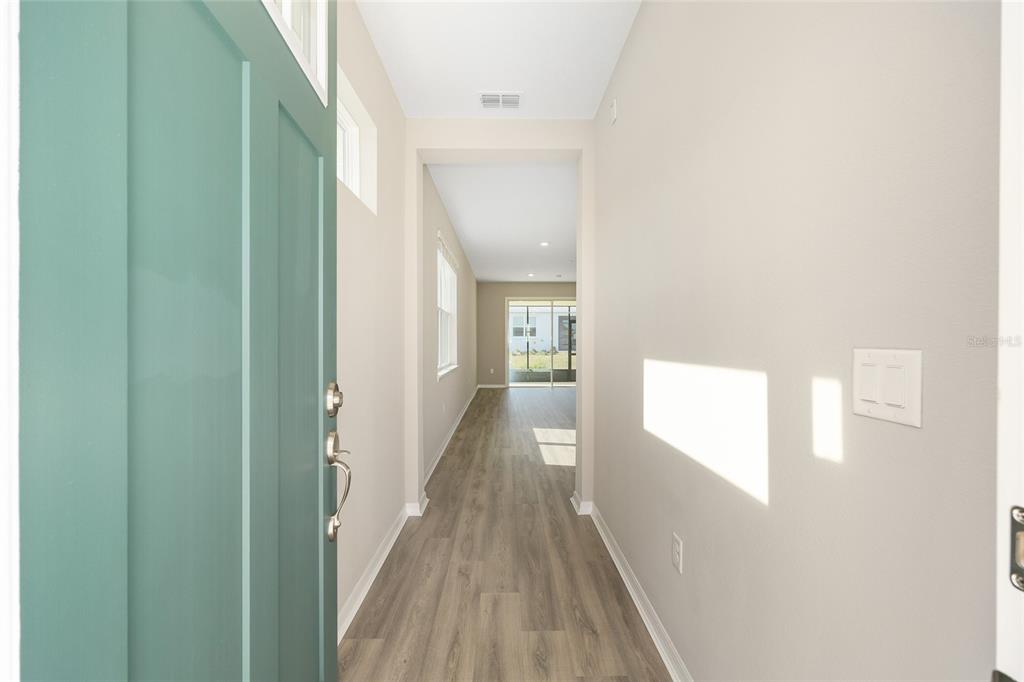 7288 Southwest 89th Avenue Ocala, FL 34481 - Photo 7 of 34 a view of a hallway with wooden floor