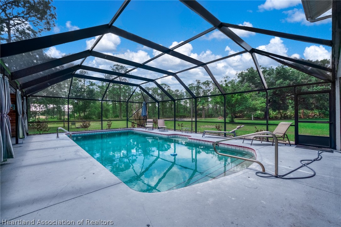 5731 Wolf Lake Road Sebring, FL 33875 - Photo 19 of 45 a view of a swimming pool with a patio