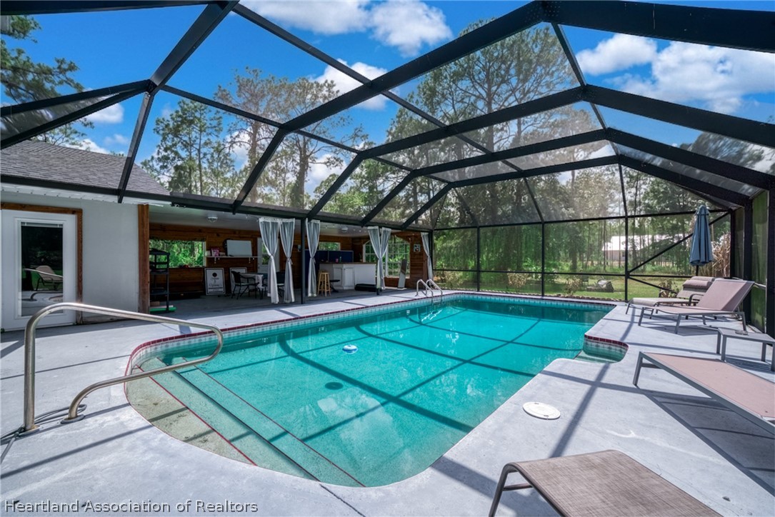 5731 Wolf Lake Road Sebring, FL 33875 - Photo 20 of 45 a view of a backyard with sitting area