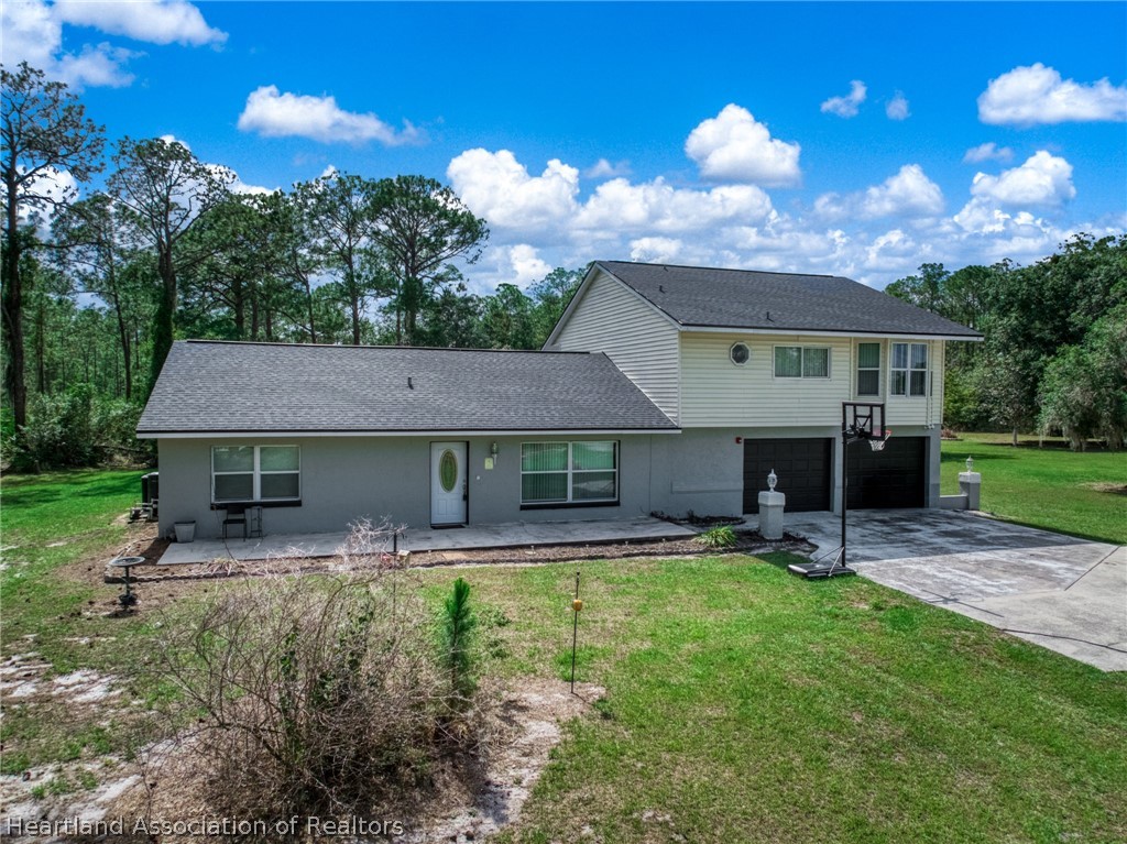 5731 Wolf Lake Road Sebring, FL 33875 - Photo 3 of 45 a view of a house with a yard