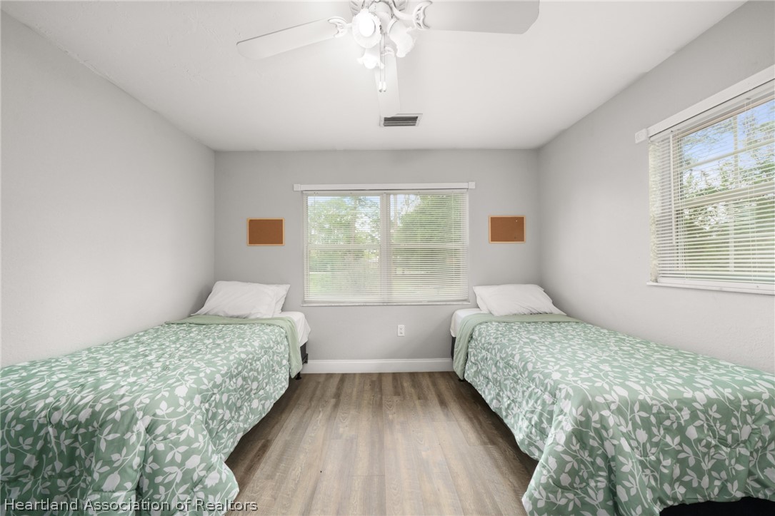 5731 Wolf Lake Road Sebring, FL 33875 - Photo 33 of 45 a bedroom with a large bed and a window
