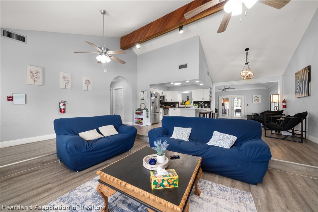 5731 Wolf Lake Road Sebring, FL 33875 - Photo 6 of 45 a living room with furniture fireplace and a chandelier