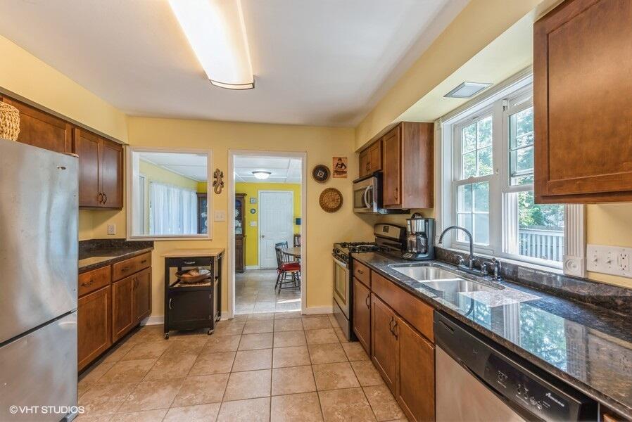 1695 Indian Boundary Road Chesterton, IN 46304 - Photo 11 of 29 a large kitchen with granite countertop a stove refrigerator and cabinets
