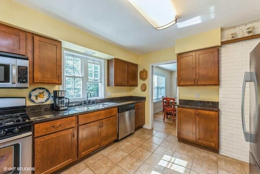 1695 Indian Boundary Road Chesterton, IN 46304 - Photo 12 of 29 a kitchen with stainless steel appliances granite countertop a stove sink and cabinets