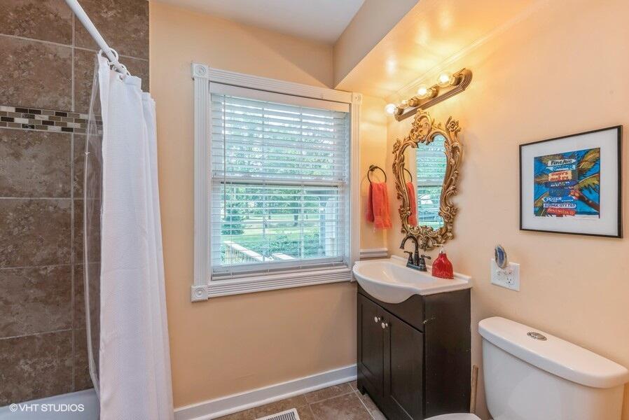 1695 Indian Boundary Road Chesterton, IN 46304 - Photo 19 of 29 a bathroom with a sink vanity mirror and toilet