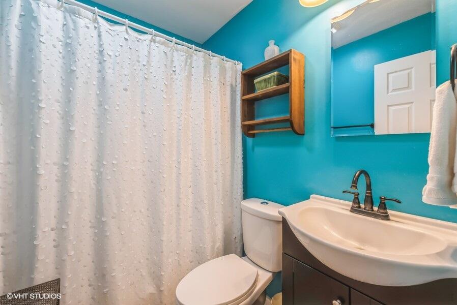1695 Indian Boundary Road Chesterton, IN 46304 - Photo 20 of 29 a bathroom with a sink a toilet and a mirror