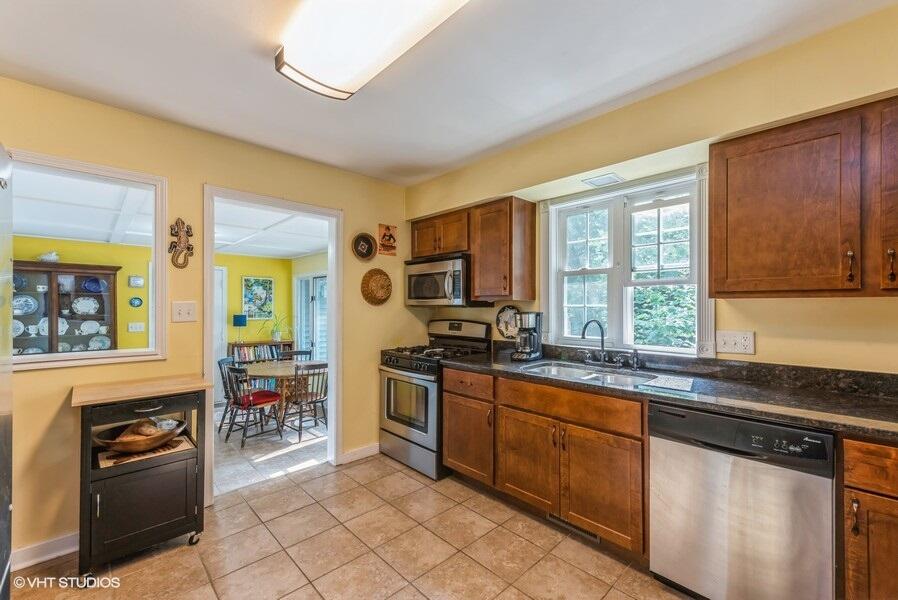 1695 Indian Boundary Road Chesterton, IN 46304 - Photo 10 of 29 a kitchen with stainless steel appliances granite countertop a stove a sink and a microwave