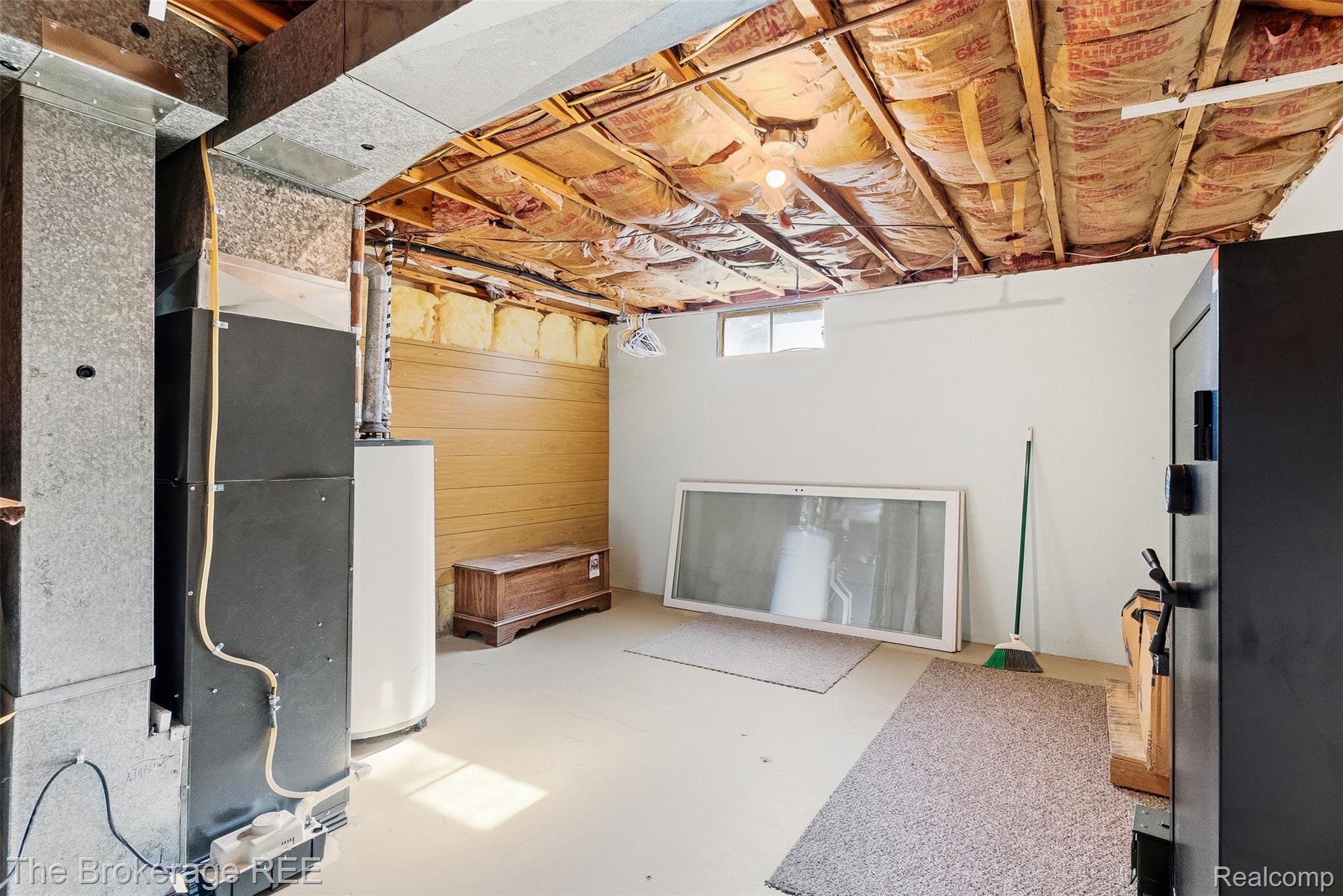 6509 Silver Lake Road Linden, MI 48451 - Photo 37 of 43 Basement area featuring exposed ceiling joists with insulation, concrete flooring, and a utility area with a water heater and HVAC system