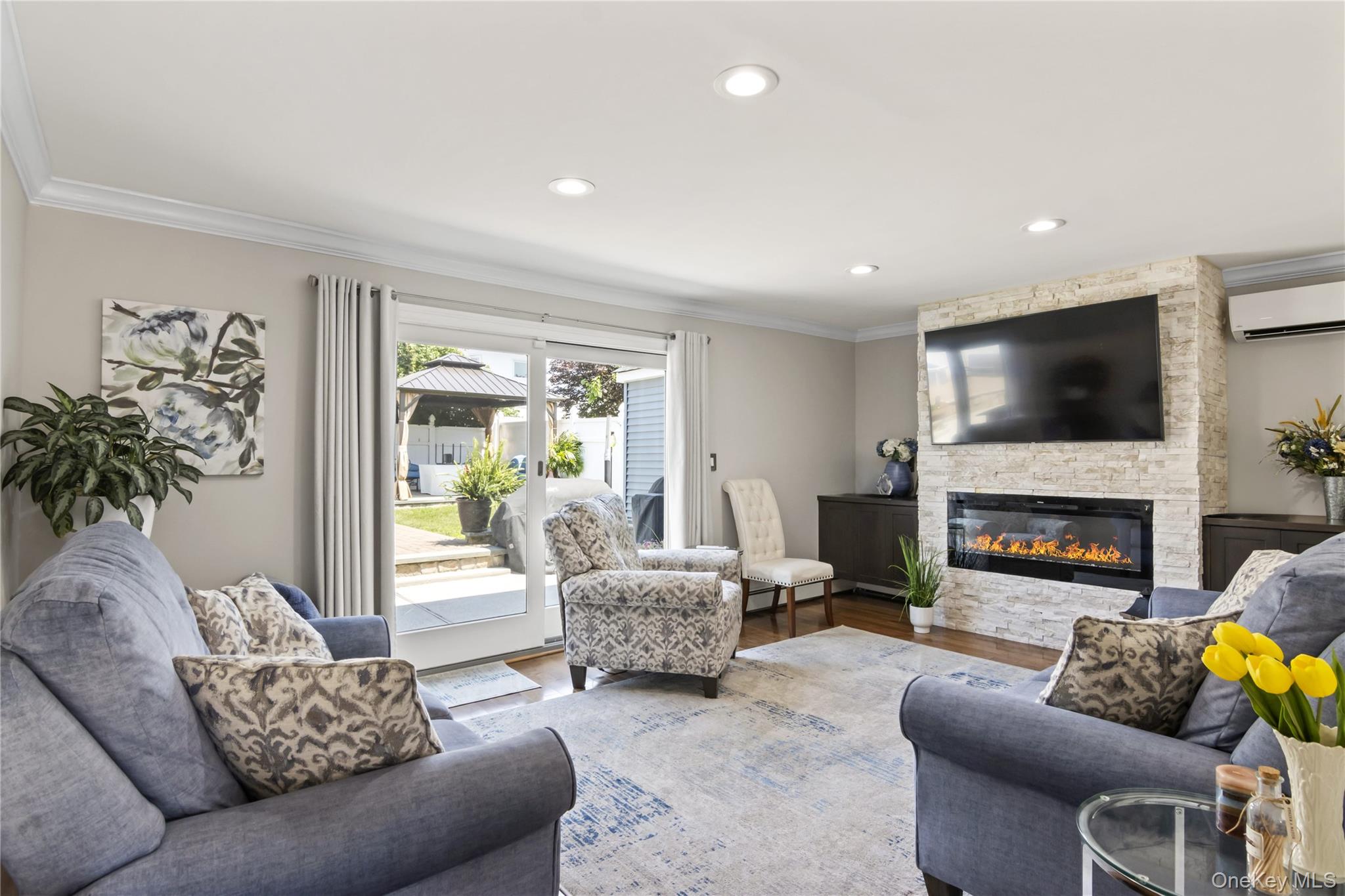 3483 Steven Road Baldwin, NY 11510 - Photo 13 of 30 a living room with fireplace furniture and a flat screen tv