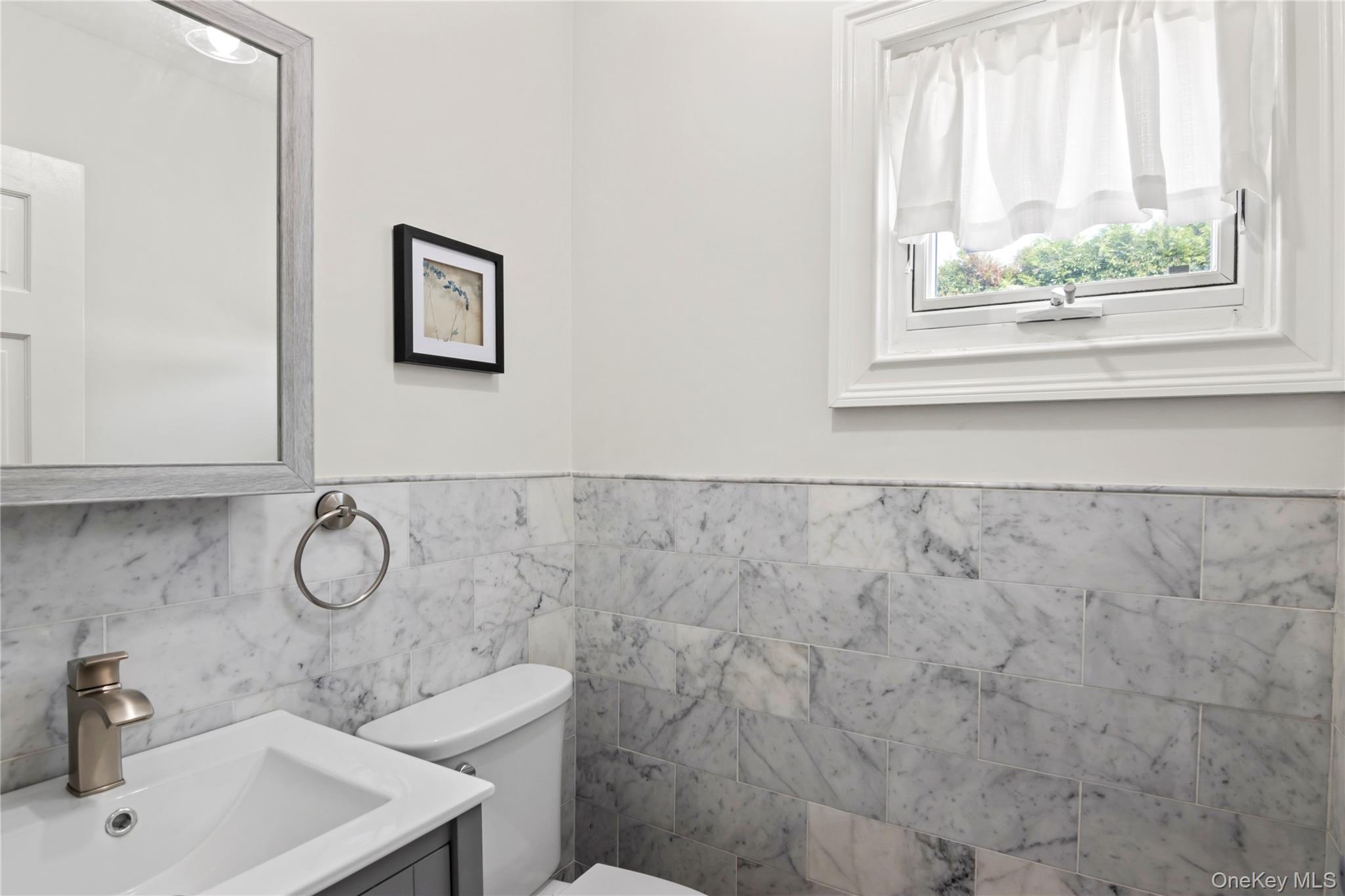 3483 Steven Road Baldwin, NY 11510 - Photo 15 of 30 a bathroom with a sink toilet and window