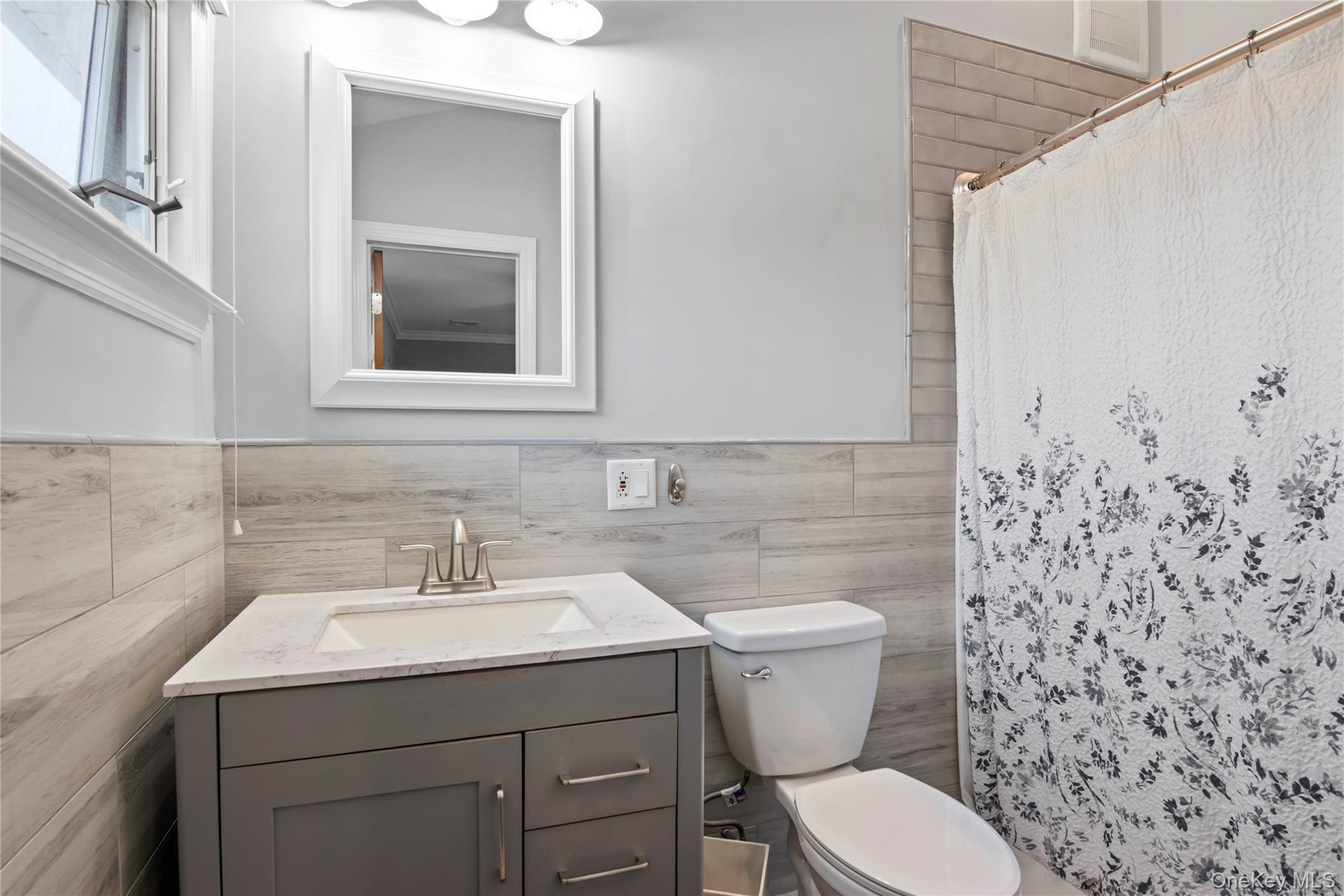 3483 Steven Road Baldwin, NY 11510 - Photo 17 of 30 a bathroom with a toilet sink and mirror