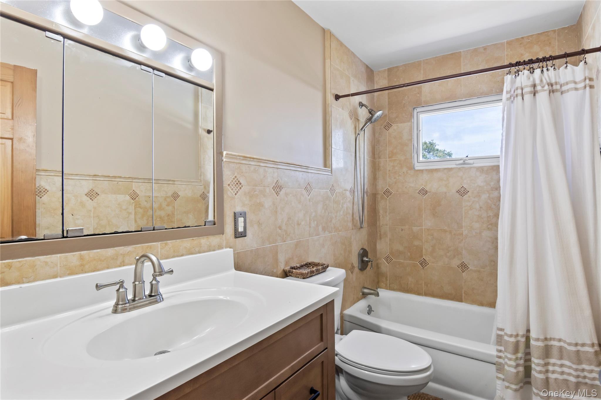 3483 Steven Road Baldwin, NY 11510 - Photo 19 of 30 a bathroom with a sink a toilet and shower