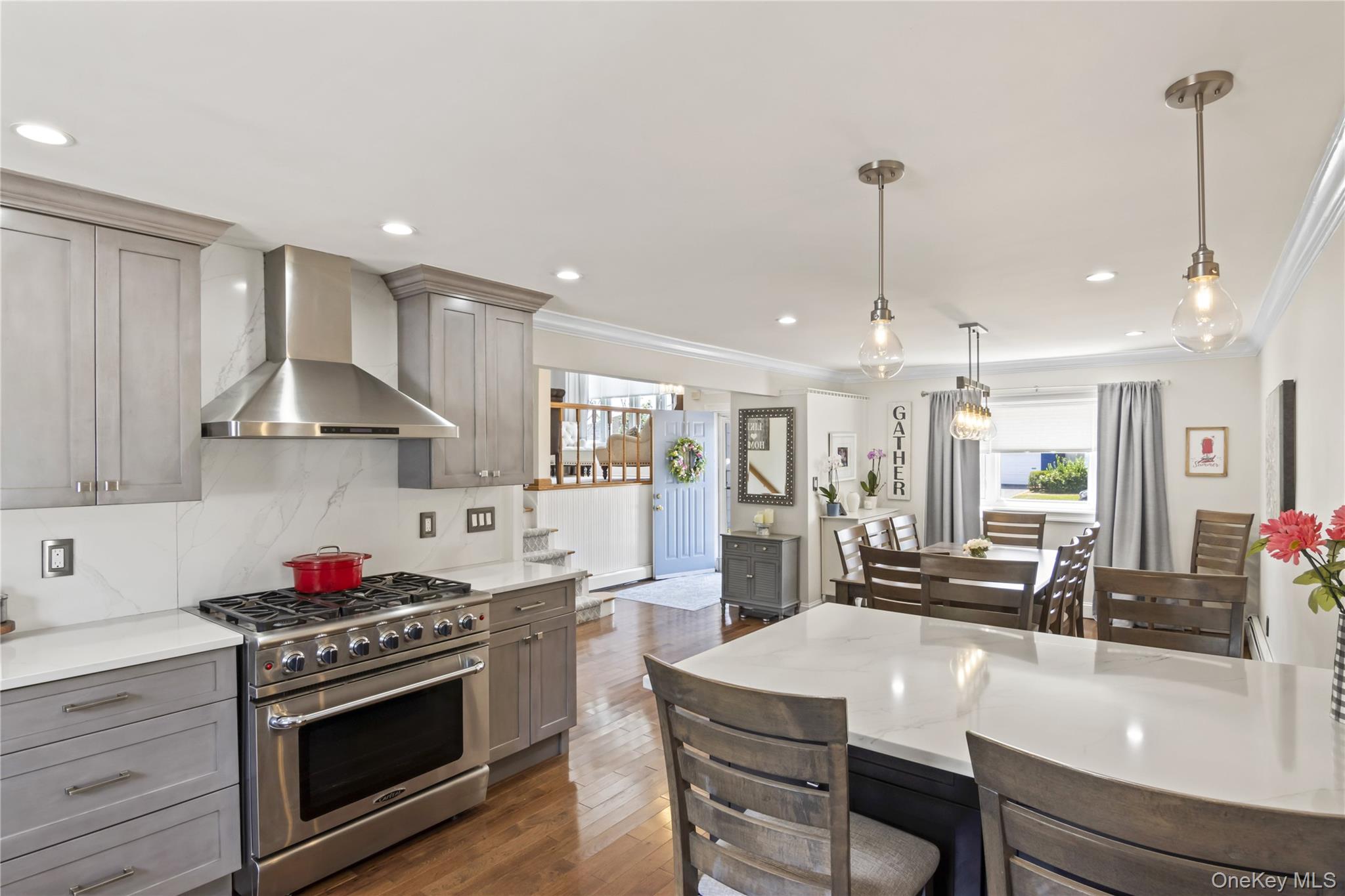3483 Steven Road Baldwin, NY 11510 - Photo 2 of 30 a kitchen with stainless steel appliances granite countertop a stove a sink a refrigerator and white cabinets with wooden floors