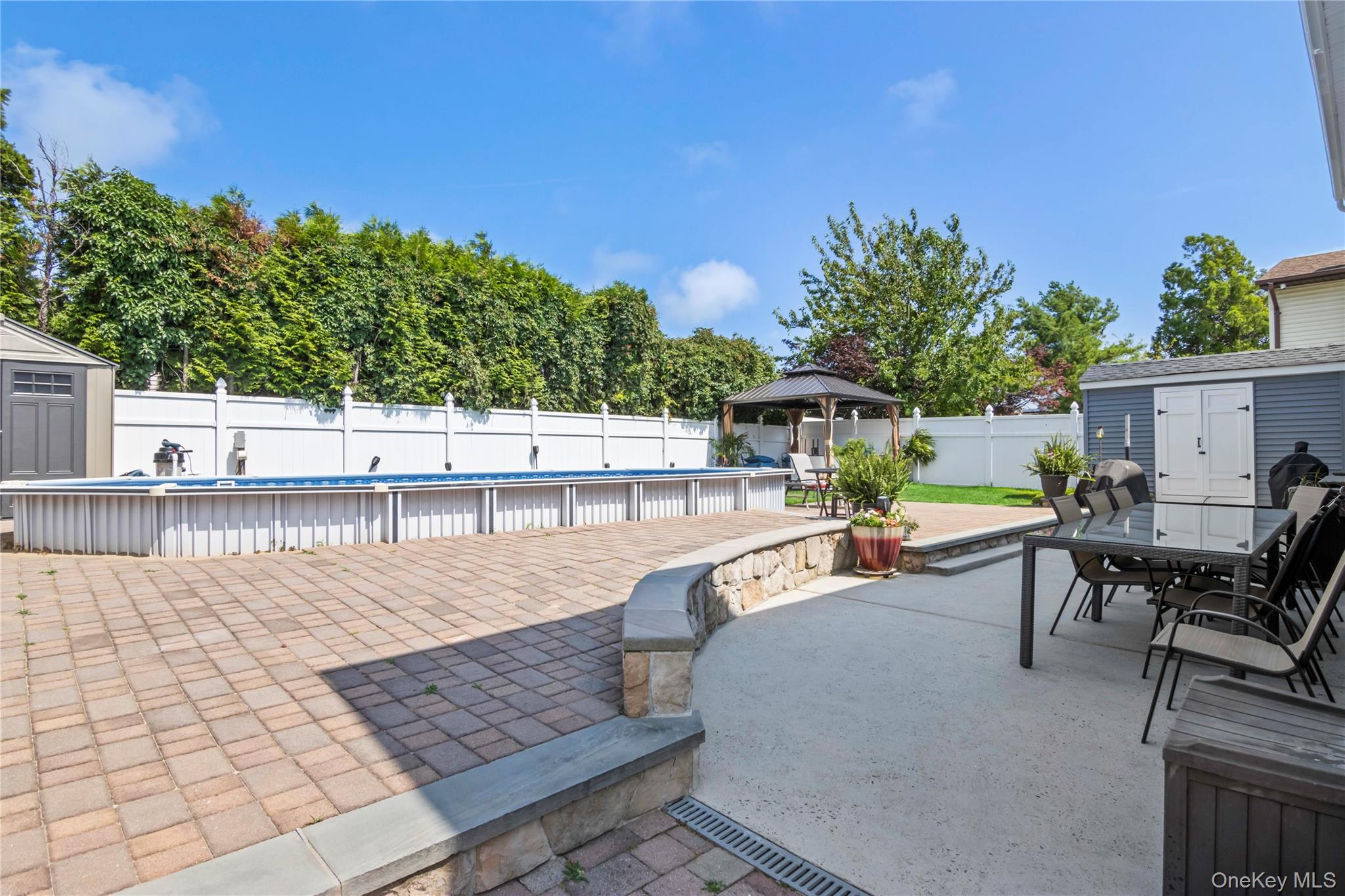 3483 Steven Road Baldwin, NY 11510 - Photo 27 of 30 a view of a swimming pool with chairs in patio