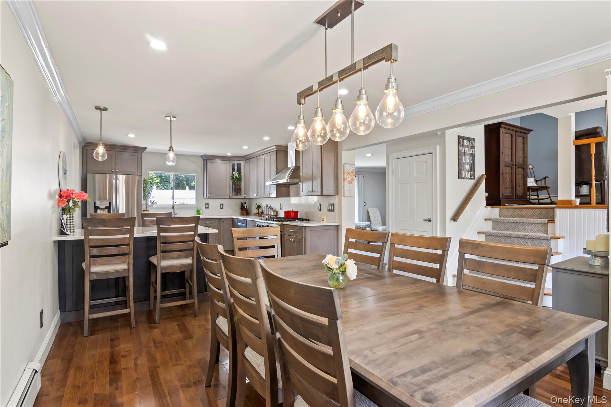 3483 Steven Road Baldwin, NY 11510 - Photo 7 of 30 a kitchen with stainless steel appliances kitchen island granite countertop a table and chairs in it