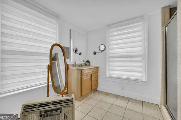 a view of washer and dryer with bathroom in the background