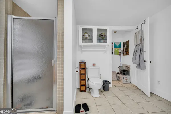 a bathroom with a granite countertop shower a mirror and a sink