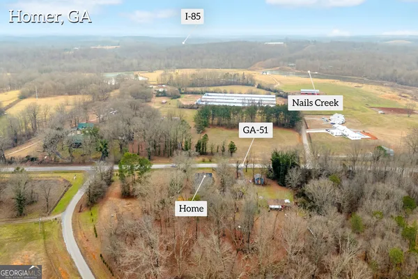 an aerial view of a house with a yard