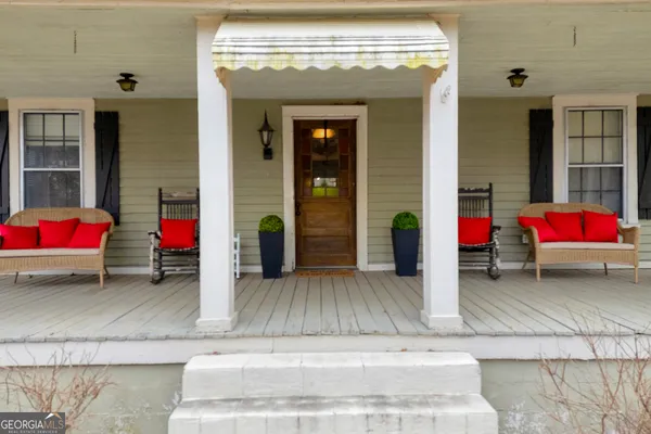 a view of a livingroom with wooden floor and furniture