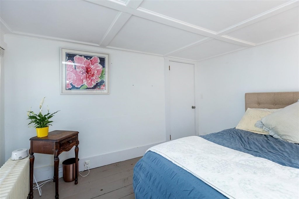 12 Linebrook Road Ipswich, MA 01938 - Photo 15 of 30 a bedroom with a bed and a painting on the wall