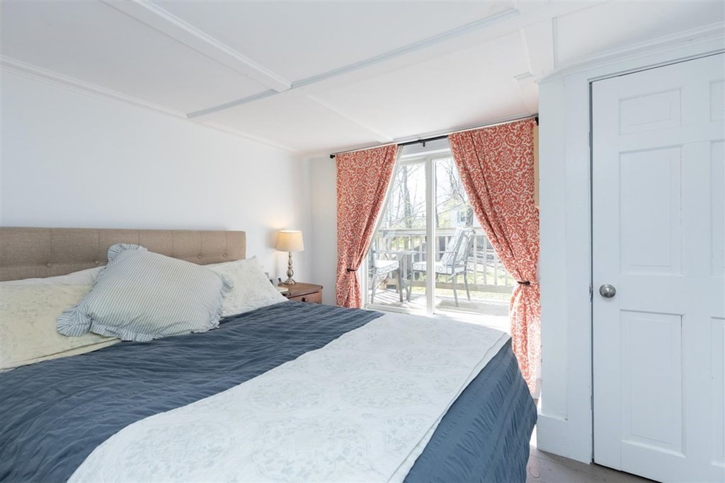 12 Linebrook Road Ipswich, MA 01938 - Photo 16 of 30 a bedroom with a bed and a large window