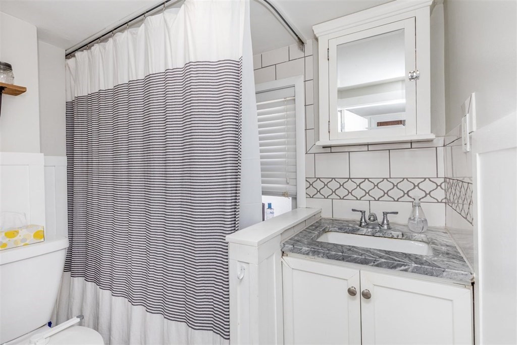 12 Linebrook Road Ipswich, MA 01938 - Photo 18 of 30 a bathroom with a granite countertop sink and a toilet