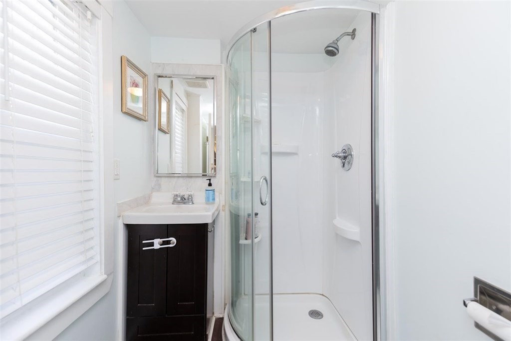 12 Linebrook Road Ipswich, MA 01938 - Photo 21 of 30 a bathroom with a shower sink and mirror