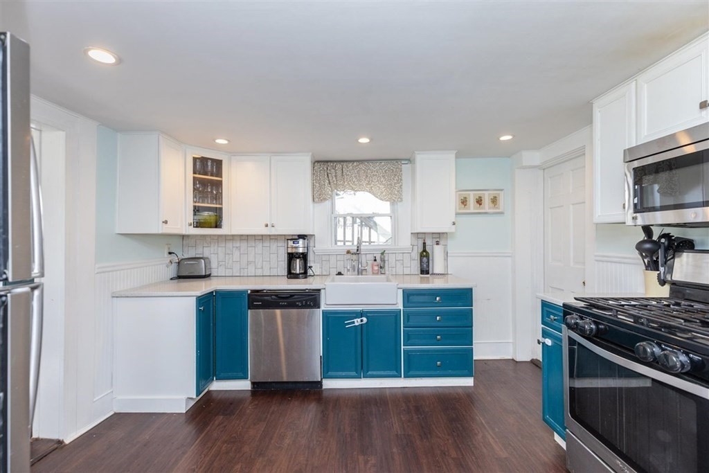 12 Linebrook Road Ipswich, MA 01938 - Photo 8 of 30 a kitchen with stainless steel appliances granite countertop a stove a sink dishwasher and a refrigerator with wooden floor